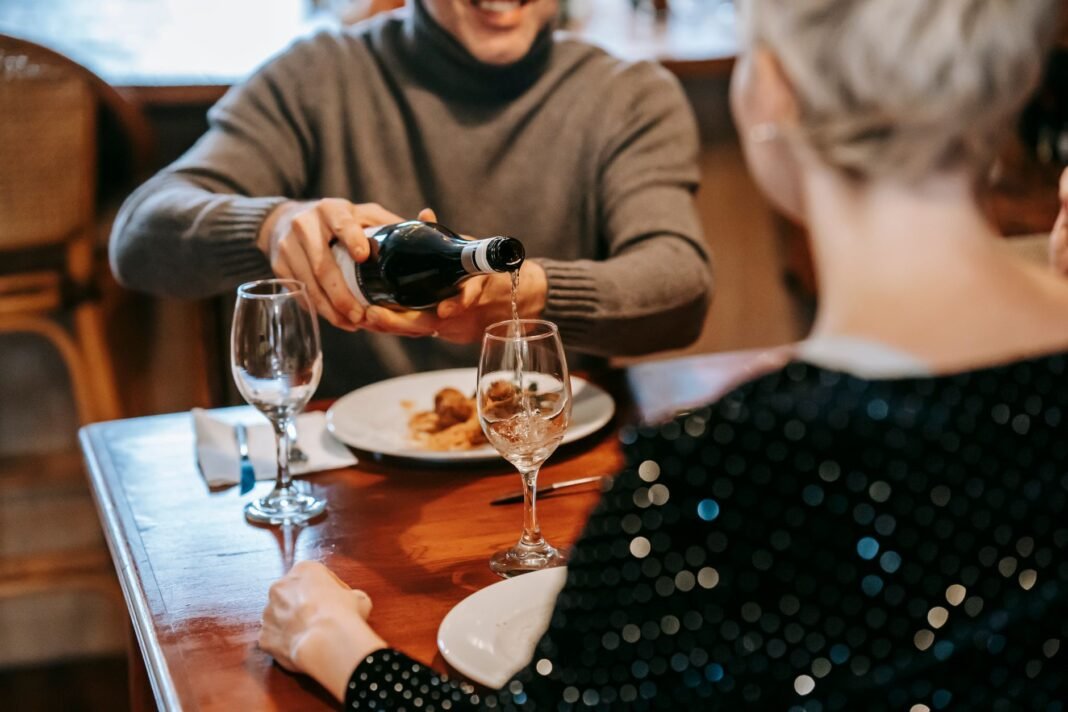 Best birthday restaurants NYC - friends celebrating over dinner at a restaurant table