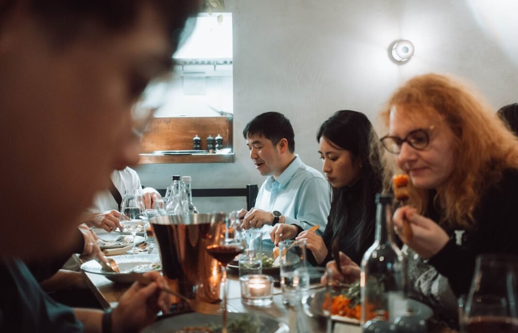 Group dinner NYC — friends sharing a meal together at a restaurant table