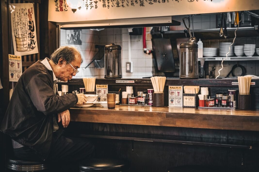 Solo dining nyc — a diner eating alone at a restaurant counter