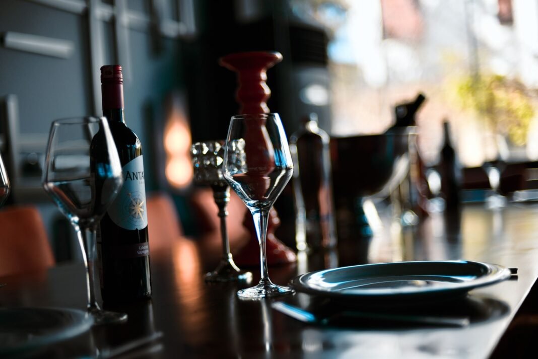 BYOB restaurants NYC — a bottle of wine and glasses on a restaurant table