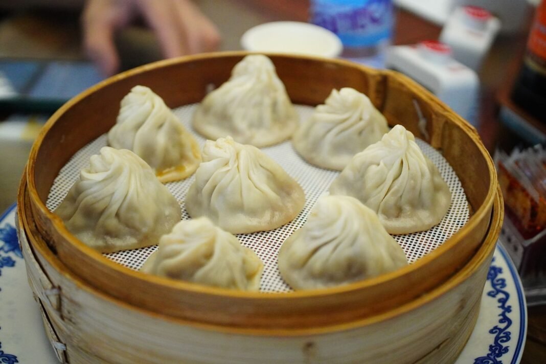 Best soup dumplings NYC - xiao long bao steaming in a bamboo basket
