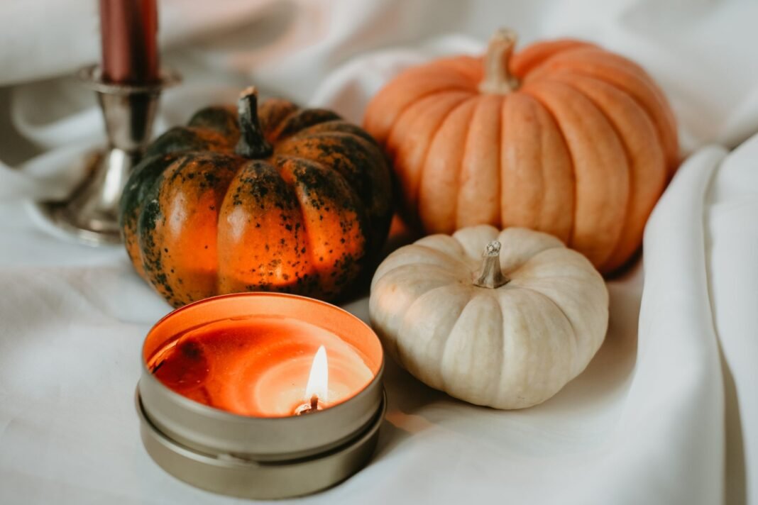 Fall themed restaurants NYC: candle and pumpkins for a cozy autumn table