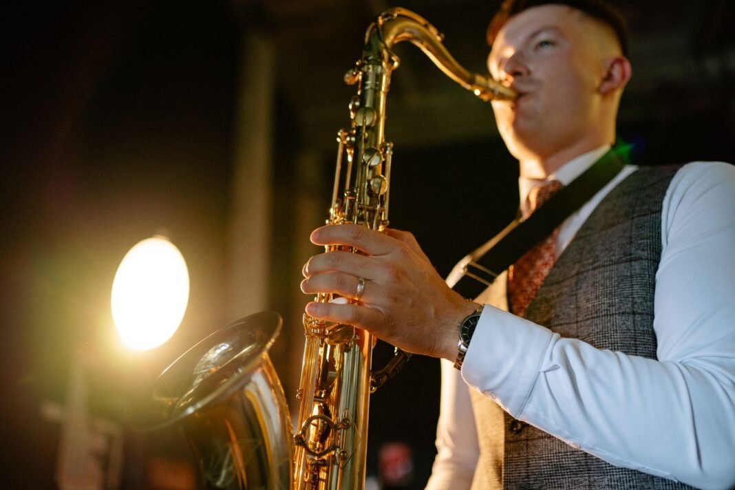 Best jazz clubs in Harlem - saxophonist playing under warm stage lights